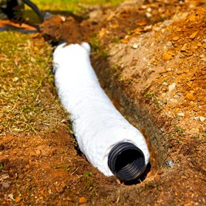 a worker installs a french drain