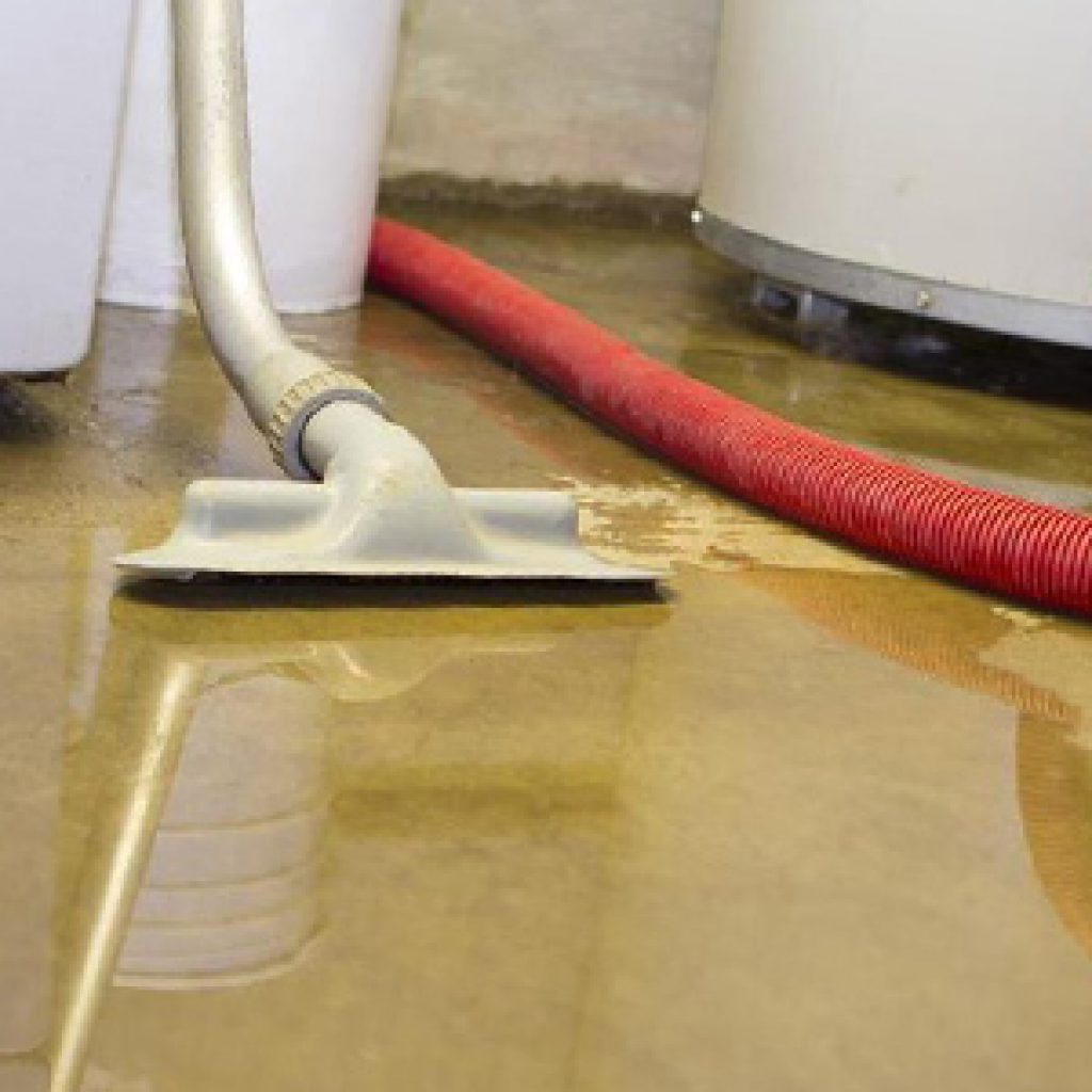 basement floor with water on it, being cleaned after a flood before backwater valve installation