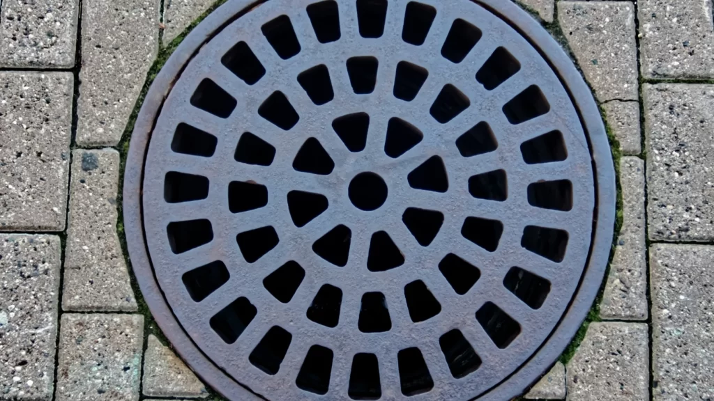A circular metal drain cover.