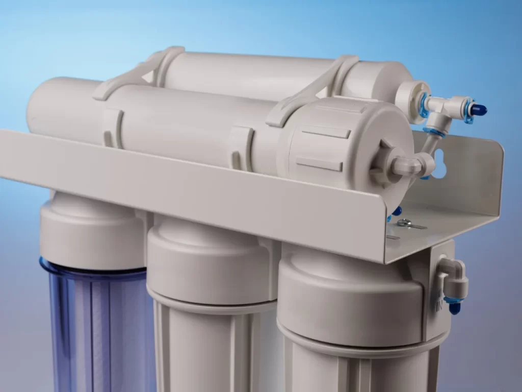 A close-up of a reverse osmosis water filtration system with multiple cylindrical filter housings and connecting tubes, set against a blue gradient background.