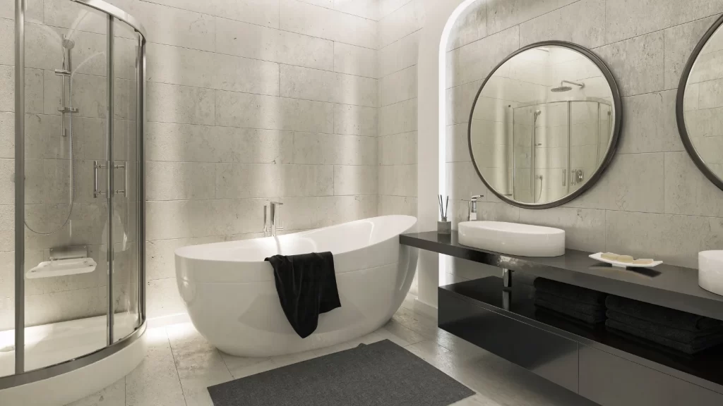 Modern bathroom with a freestanding white bathtub, a glass-enclosed shower, a double-sink vanity with two round mirrors, and neatly folded towels. Neutral tones and minimalist decor create a sleek, clean look.